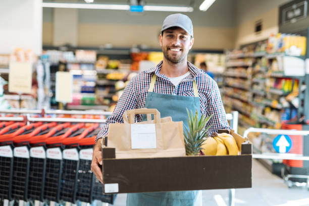 istock Delivery person holding orders from grocery store 1364737804