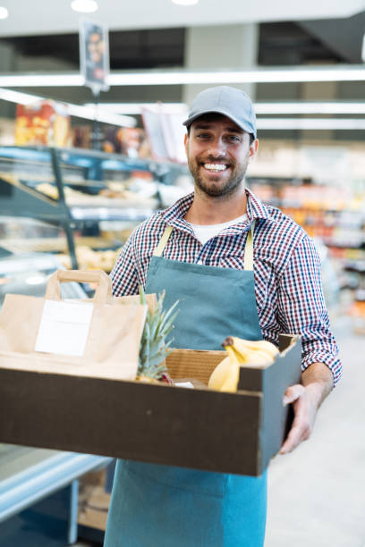 istock Delivery person holding orders from grocery store 1364737845