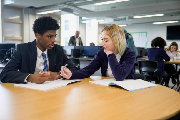 istock Teenage classmates debating ideas in collaborative workspace 1364737918