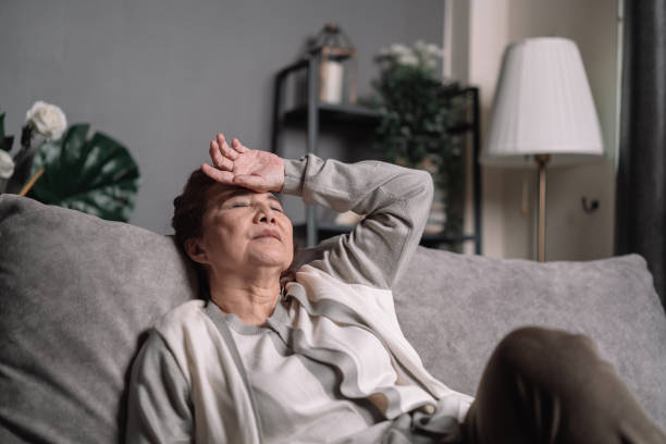 Elderly woman feel serious and worried about her life while sitting on the sofa at home. Old female sick or headache. Senior Asian woman feel serious and worried on her life while sitting on sofa at home. Old female sick or headache. headache stock pictures, royalty-free photos & images