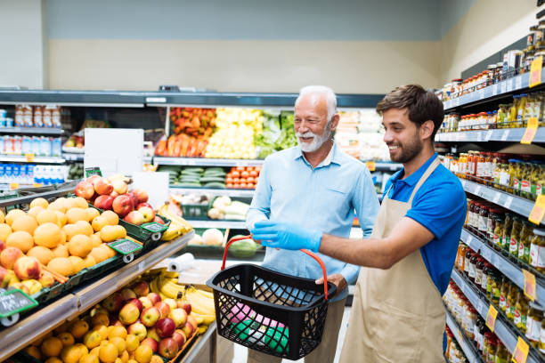 istock Employee in supermarket arranging fresh fruit 1364737988