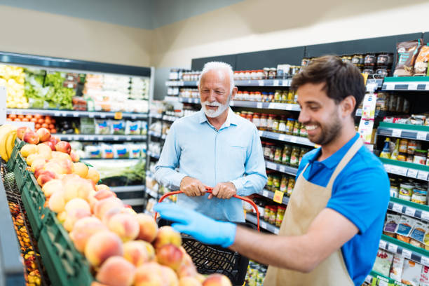 istock Employee in supermarket arranging fresh fruit 1364738022