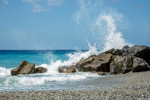 High wave breaking on the rocks of the coastline in Italy.