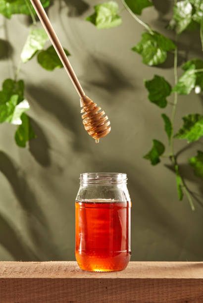 istock Delicious honey in jar on table 1364740214