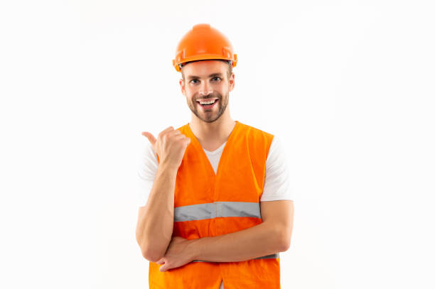 istock man in orange reflective vest and helmet pointing finger isolated on white background, engineer 1364741473