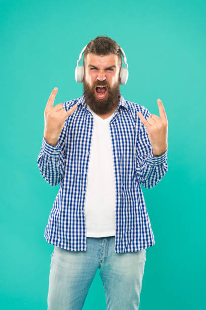 istock Heavy metal and hard rock. Streaming music sites. Wireless technology. User friendly interface and large library of tunes. Hipster with beard listening music. Handsome music lover. Man in headphones 1364742387