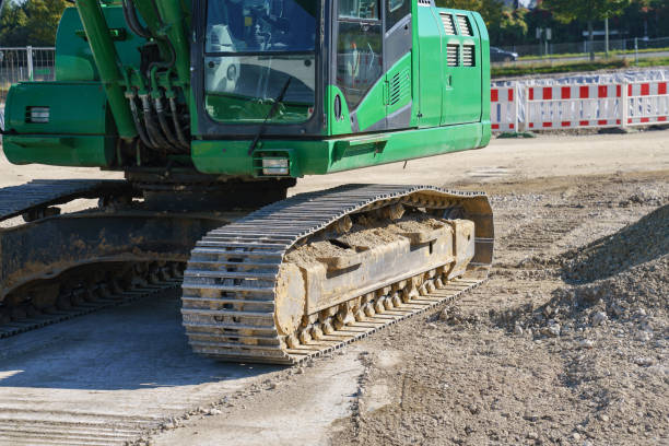 Part of the green excavator cabin at the construction site.