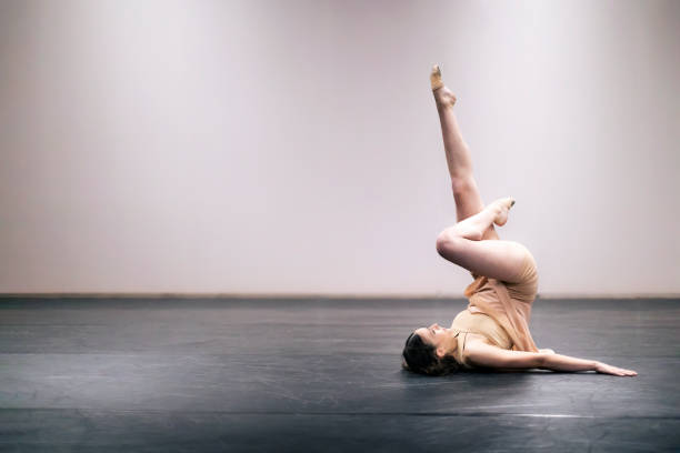 istock Young girl performing contemporary dance on stage 1364744508