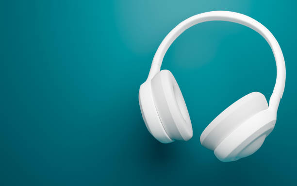 istock 3D Rendering white headphones on turquoise background. Horizontal banner. 1364745255