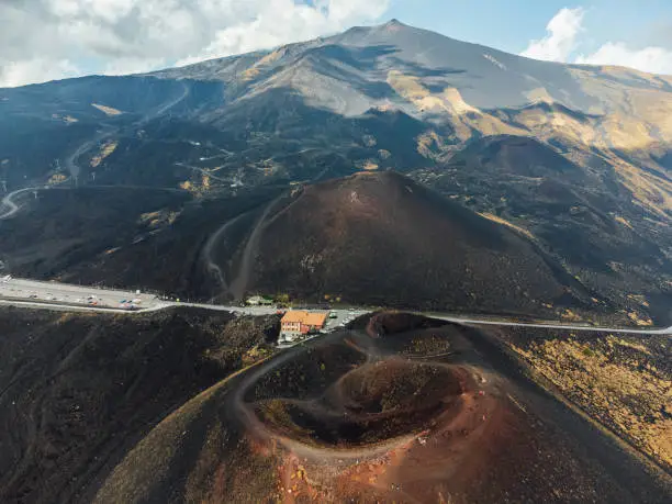 Aerial view of Mount Etna, an active volcano in Sicily, Italy. Black ground around the volcano.