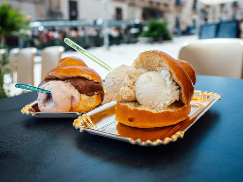 Typical dessert of Sicily: brioche with ice-cream. Italian traditional sweet food.