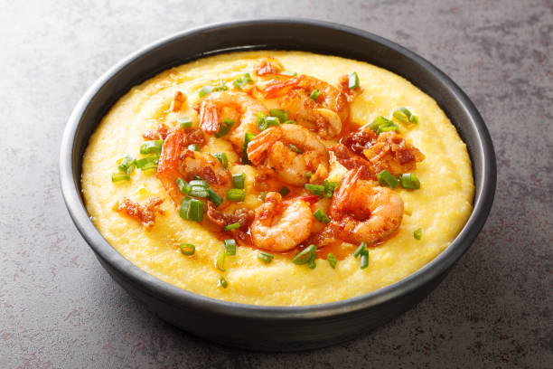 delicious yellow grits with cheese, shrimps and bacon close-up in a plate. horizontal - grits prepared shrimp restaurant food imagens e fotografias de stock