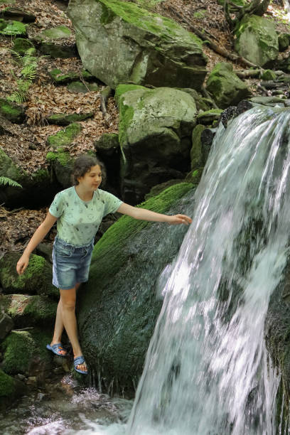 istock girl near the stream 1364750224