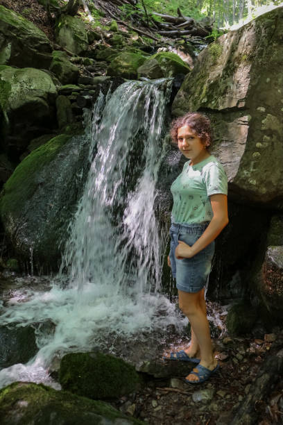 istock girl near the stream 1364750238