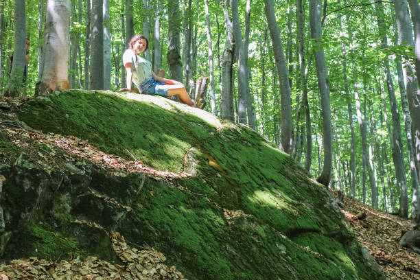 istock girl on the stone 1364750337