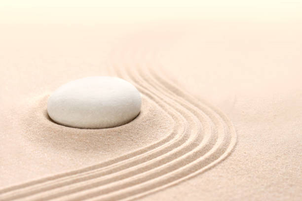 istock Round stones on a sandy background 1364750658