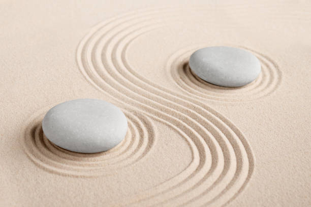 istock Round stones on a sandy background 1364750759