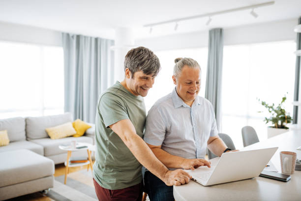 istock Mature gay couple working from home 1364750983
