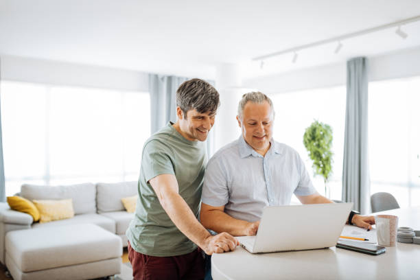 istock Mature gay couple working from home 1364751578