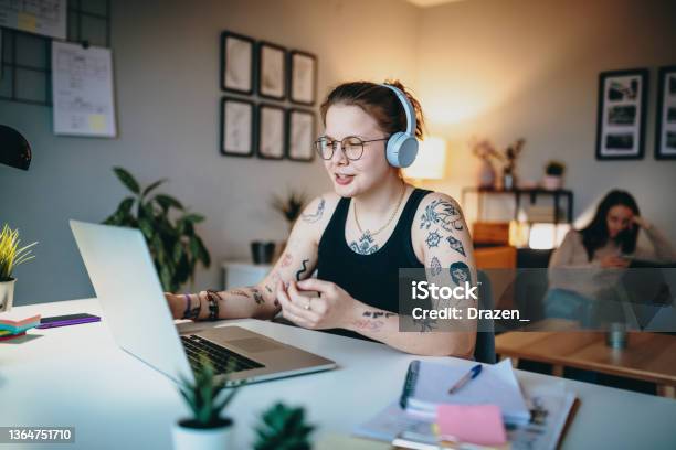Lesbian Couple Using Laptop For Freelance Work And Video Calls Stock Photo - Download Image Now