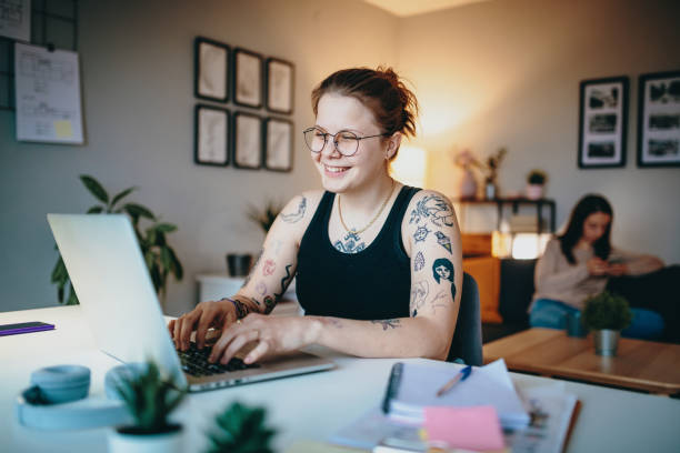 istock Lesbian couple using laptop for freelance work and video calls 1364751745