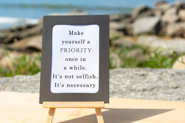 Motivational and Inspirational quote on a notepad with blurred beach background stock photo