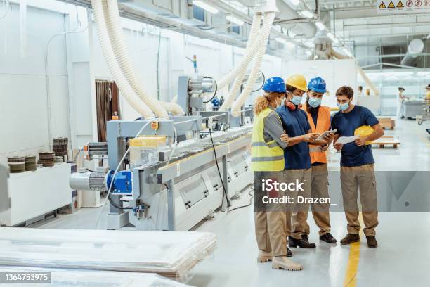 Employees In Factory Wearing Face Masks During Meeting Stock Photo - Download Image Now