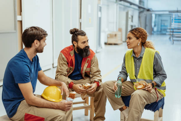 istock Blue collar workers eating breakfast during the shift break in factory 1364754120