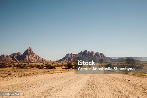 istock Driving the gravel road with scenic view of the Namibian landscape 1364754714