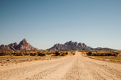 istock Driving the gravel road with scenic view of the Namibian landscape 1364754714