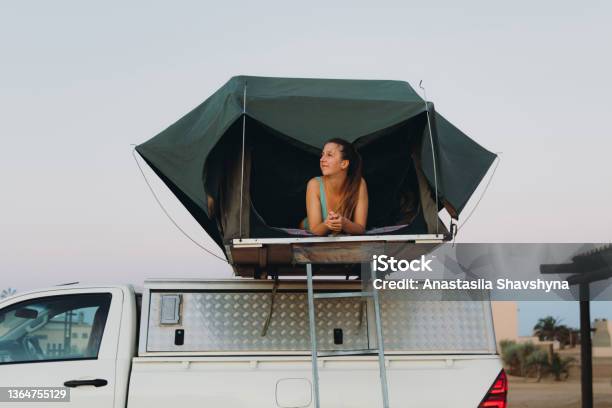 Happy Female Traveler Relaxing In The Camper Truck By The Beach In Namibia Stock Photo - Download Image Now