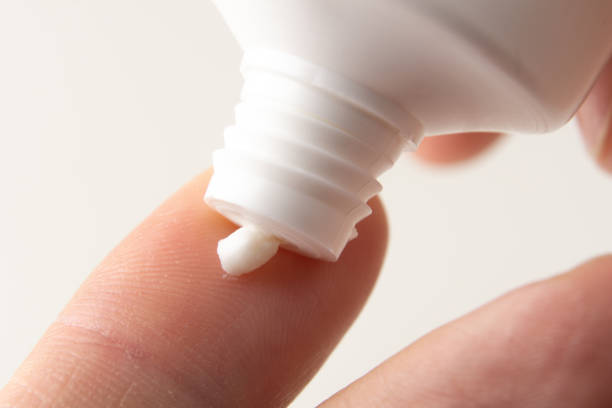 istock Cream is squeezed onto a man's finger from a white tube. Using hand cream. 1364757146