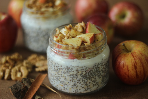 Overnight oats with apple and almonds. Made by soaking rolled oats and chia seeds in milk served with chopped apples, cinnamon, almonds and honey for a chilled, yummy, healthy and easy breakfast