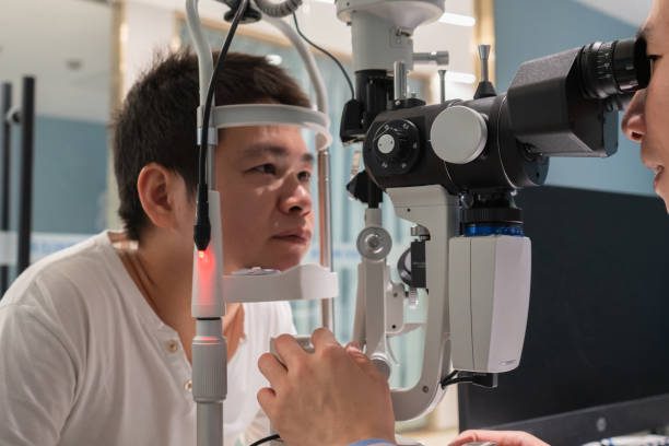 istock Ophthalmologist is using instrument to examine patient's eyes 1364760644