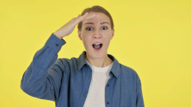 istock Young Woman Looking Around, Searching Yellow Screen 1364760676