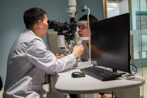 istock Ophthalmologist is using instrument to examine patient's eyes 1364760886