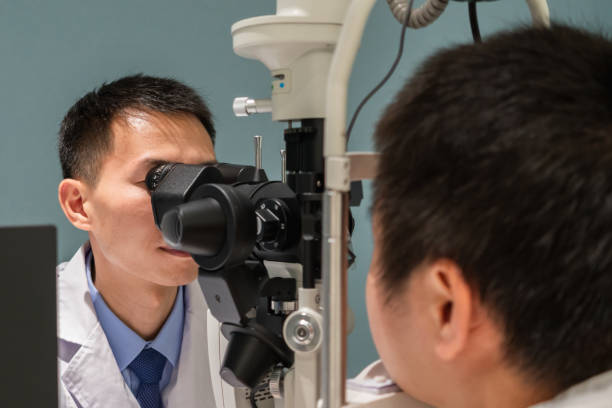 istock Ophthalmologist is using instrument to examine patient's eyes 1364760889