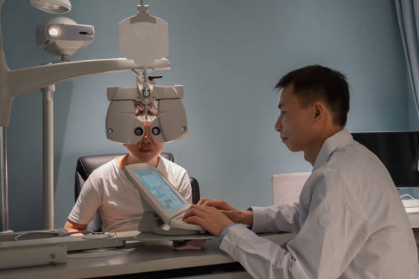 istock Ophthalmologist is using instrument to examine patient's eyes 1364762078
