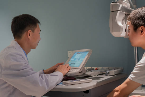 istock Ophthalmologist is using instrument to examine patient's eyes 1364762161