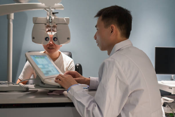 Ophthalmologist is using instrument to examine patient's eyes