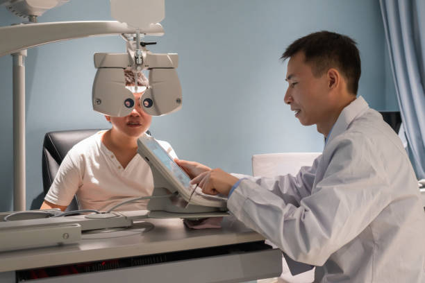 istock Ophthalmologist is using instrument to examine patient's eyes 1364762266