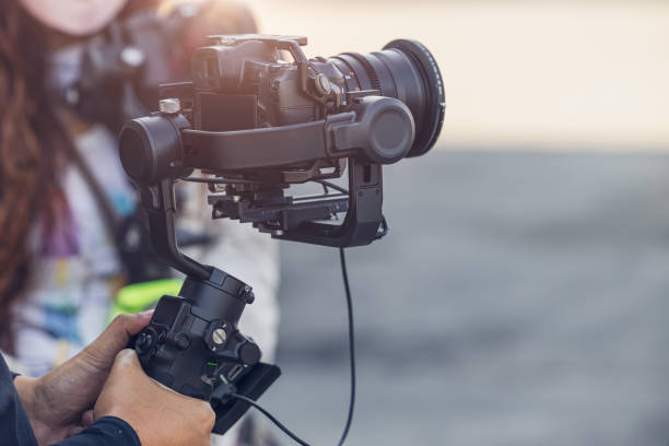 istock Motorized Gimbal, people using digital camera with anti shake for video production scene stabilizer 1364766735