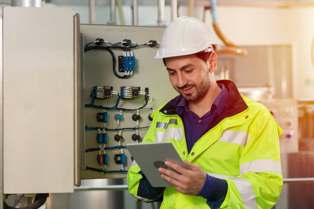 istock engineer worker working checking maintenance electricity fuse box in and power line in factory. 1364767078