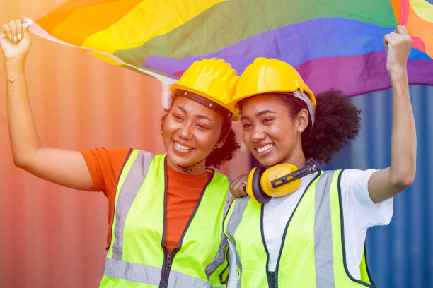 women worker with LGBTQ flag for transgender and sexual diversity people campaign stock photo