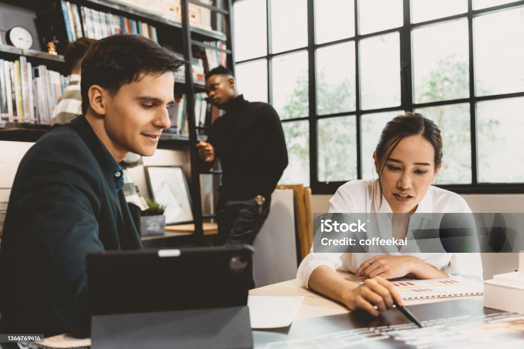 Smart Asian working women discuss project with male team work in modern office Lead Stock Photo