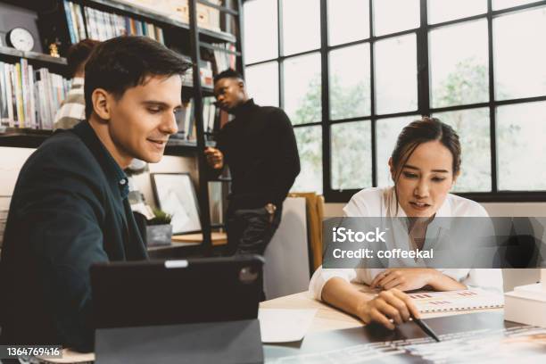 Smart Asian Working Women Discuss Project With Male Team Work In Modern Office Stock Photo - Download Image Now