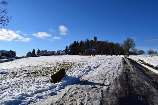 castle Nürburg in snow covered winter landscape of the Eifel Nürburg, Germany - 01/11/2022 : castle Nürburg in snow covered winter landscape of the Eifel nürburgring stock pictures, royalty-free photos & images