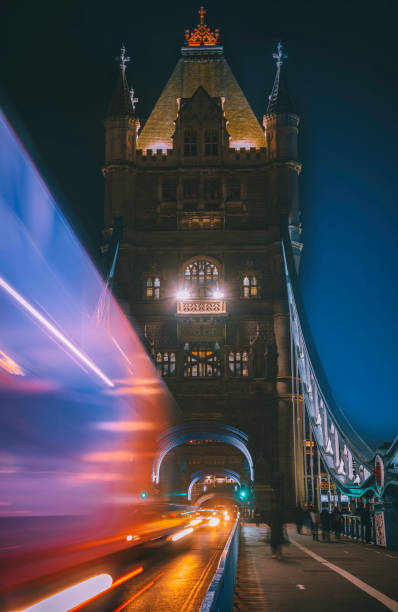istock Speeding double-decker light trails on Tower Bridge at night in London, UK 1364773403