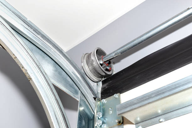 istock Guides for the home garage door, visible cable drum with steel rope, inside view. 1364780009