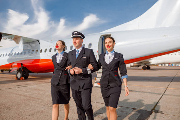 istock Aircraft pilot and stewardesses walking down airfield 1364780389